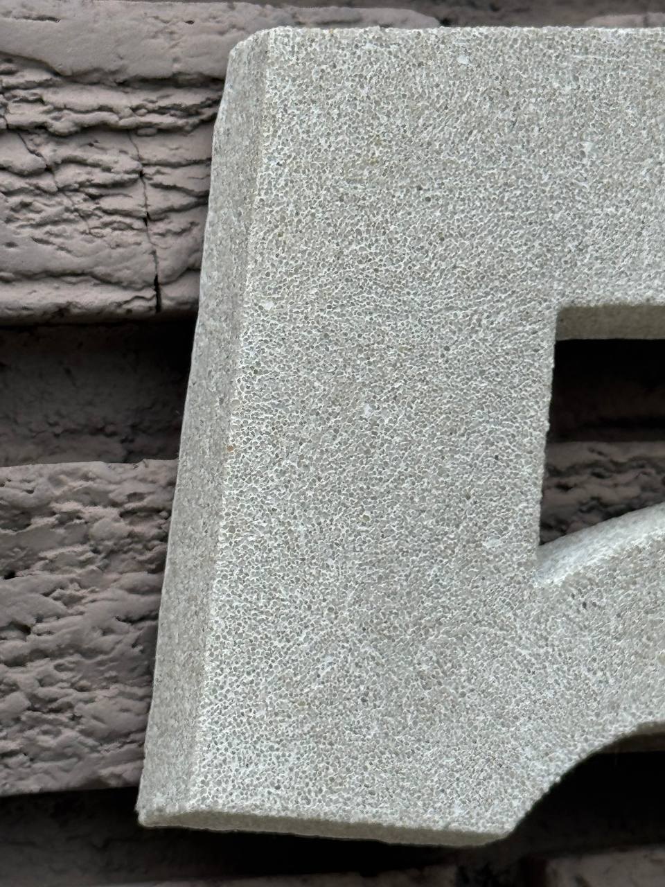 Close-up of handcrafted GFRC texture and dimensional number edge