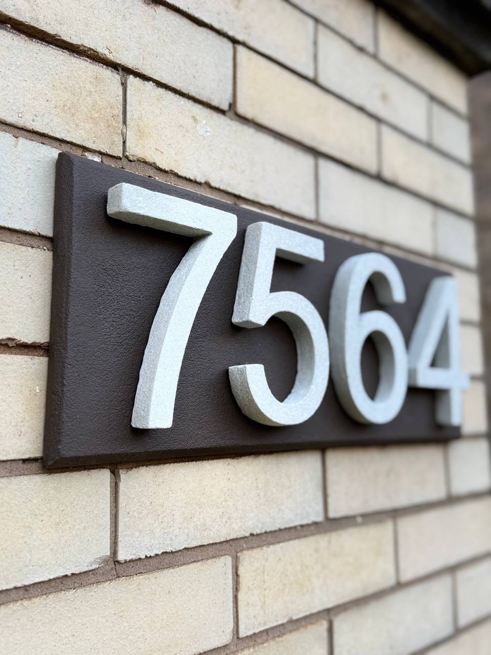 Heritage Brown GFRC address plaque with light raised numbers on masonry