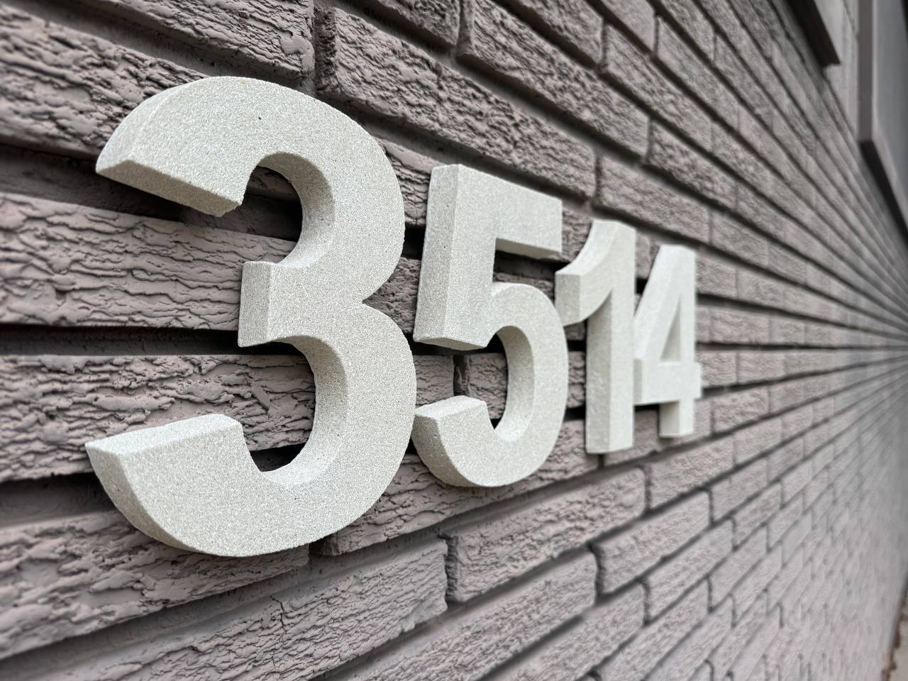 Angled view showing dimensional depth of GFRC house numbers