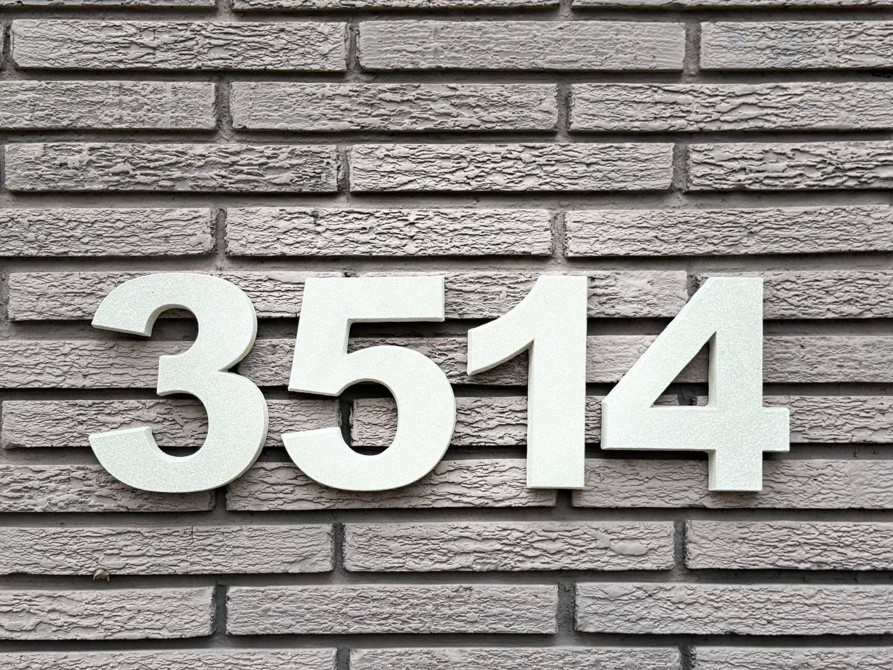 Straight-on view of individual architectural GFRC house numbers