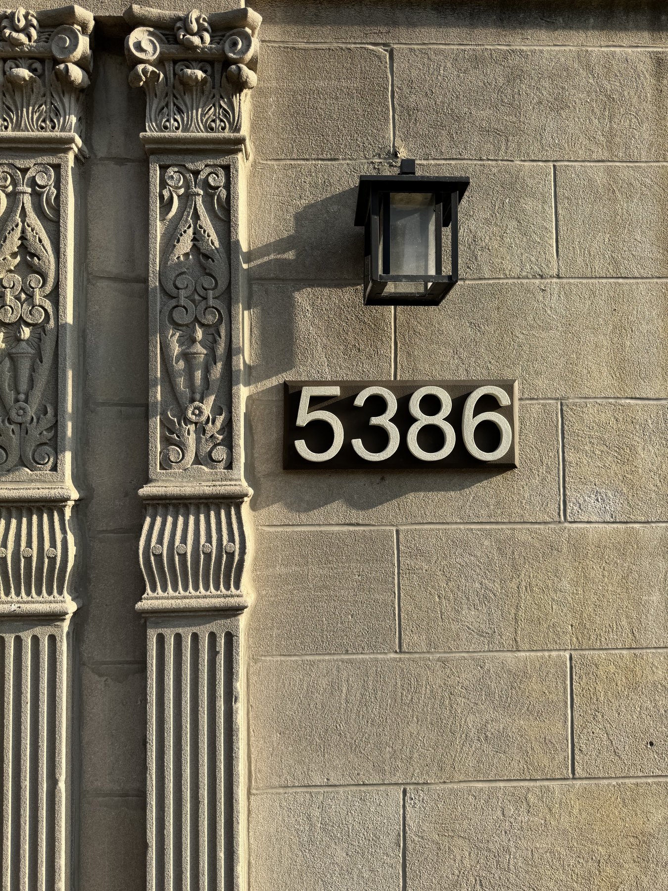 Real installed 5386 GFRC address plaque in architectural facade context