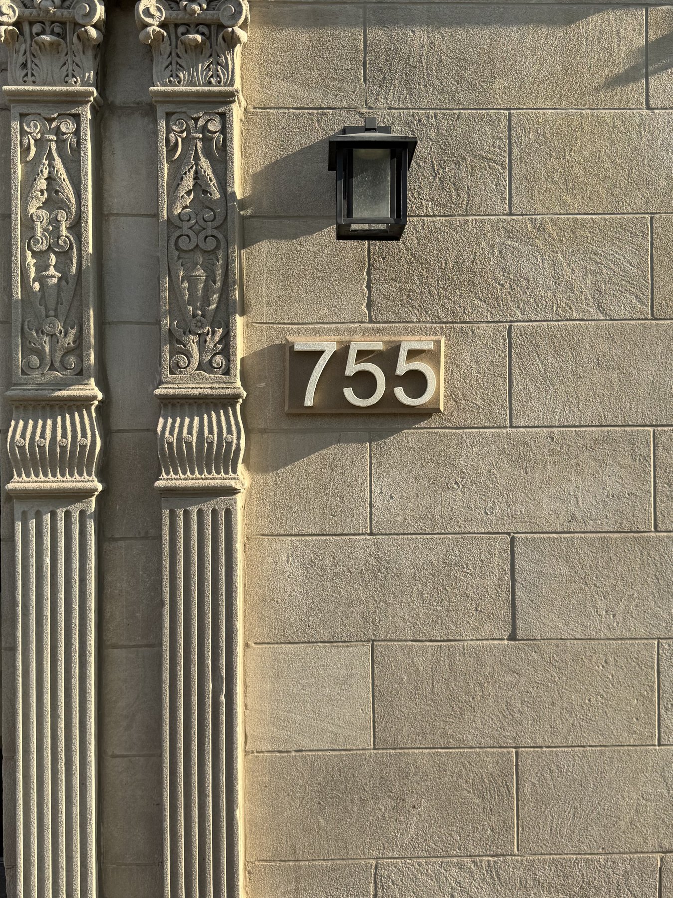 Real installed 755 GFRC address plaque in architectural facade context