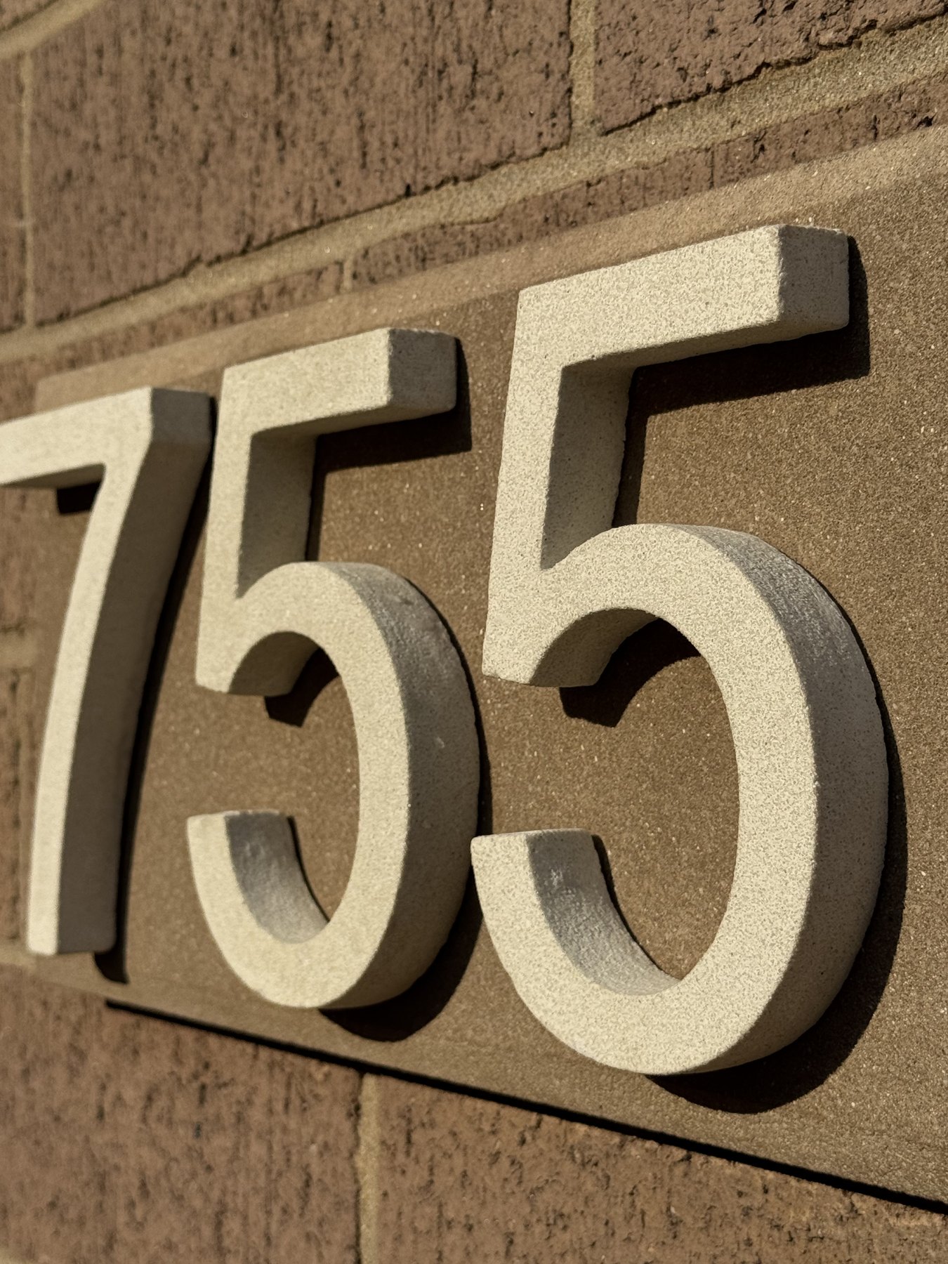 Close-up angled view showing raised dimensional depth on a 755 GFRC address plaque