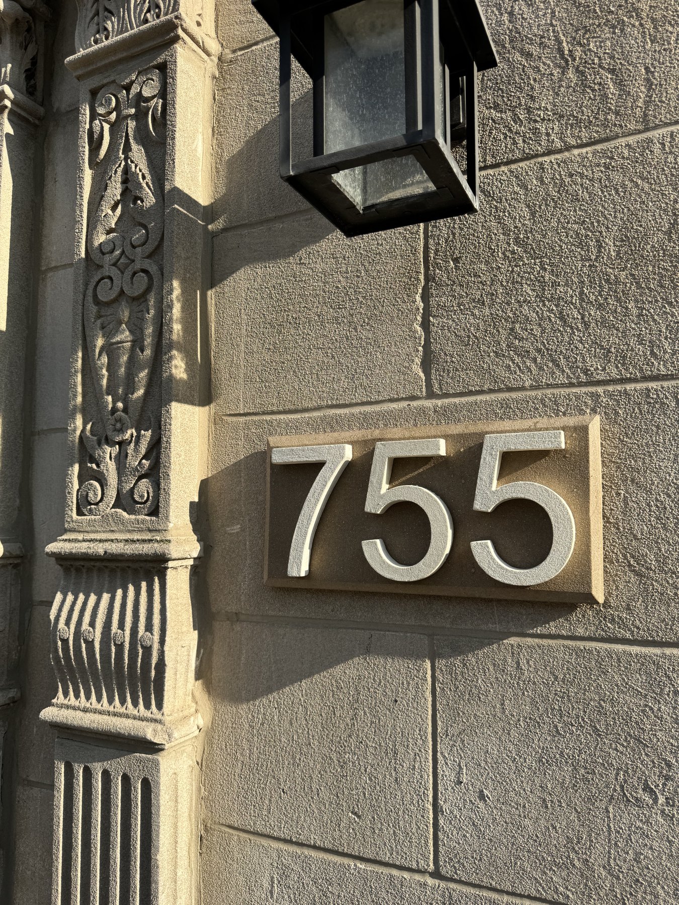 Angled real installed 755 GFRC address plaque with lantern detail