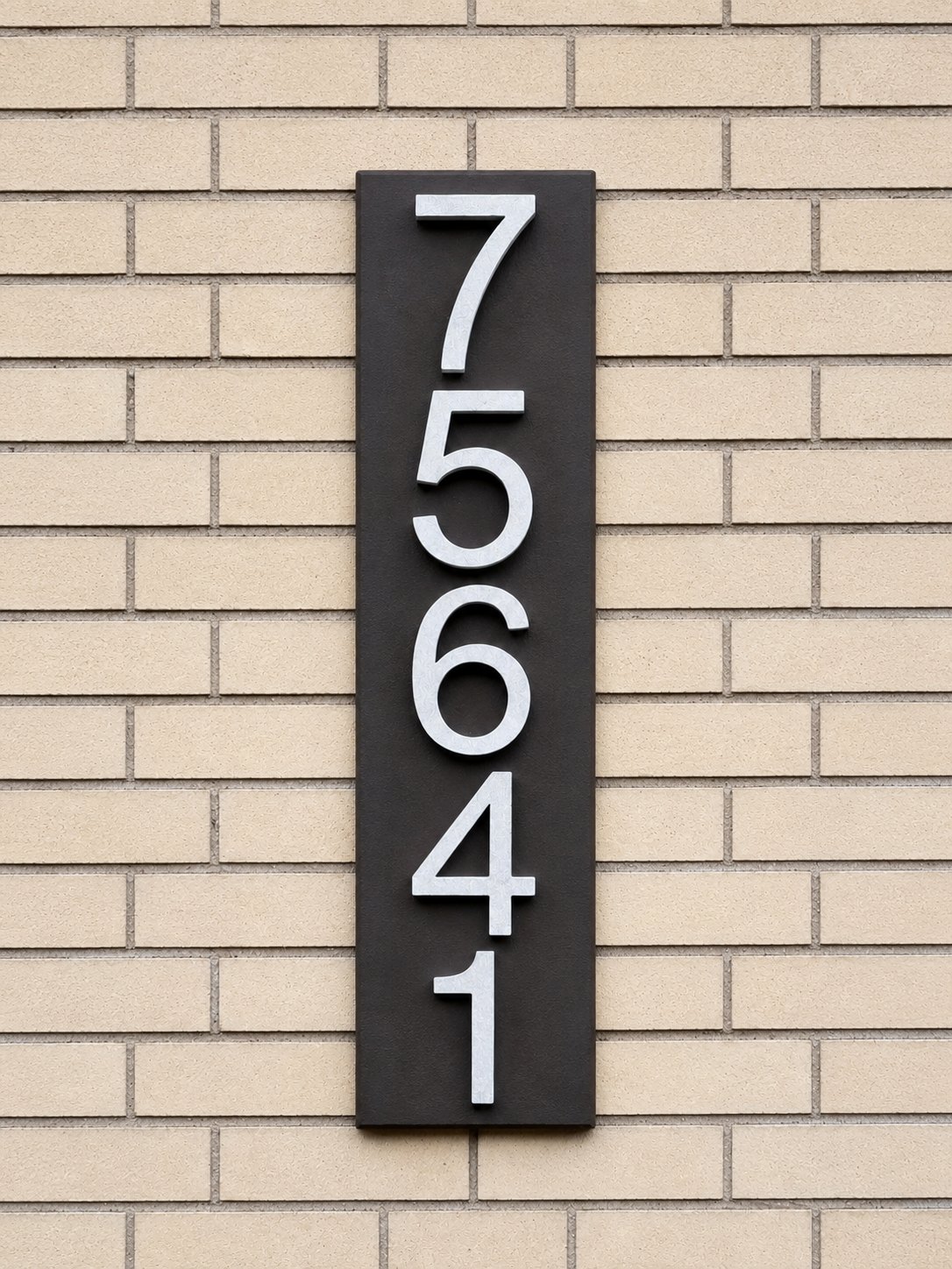 Vertical GFRC address plaque layout on light brick