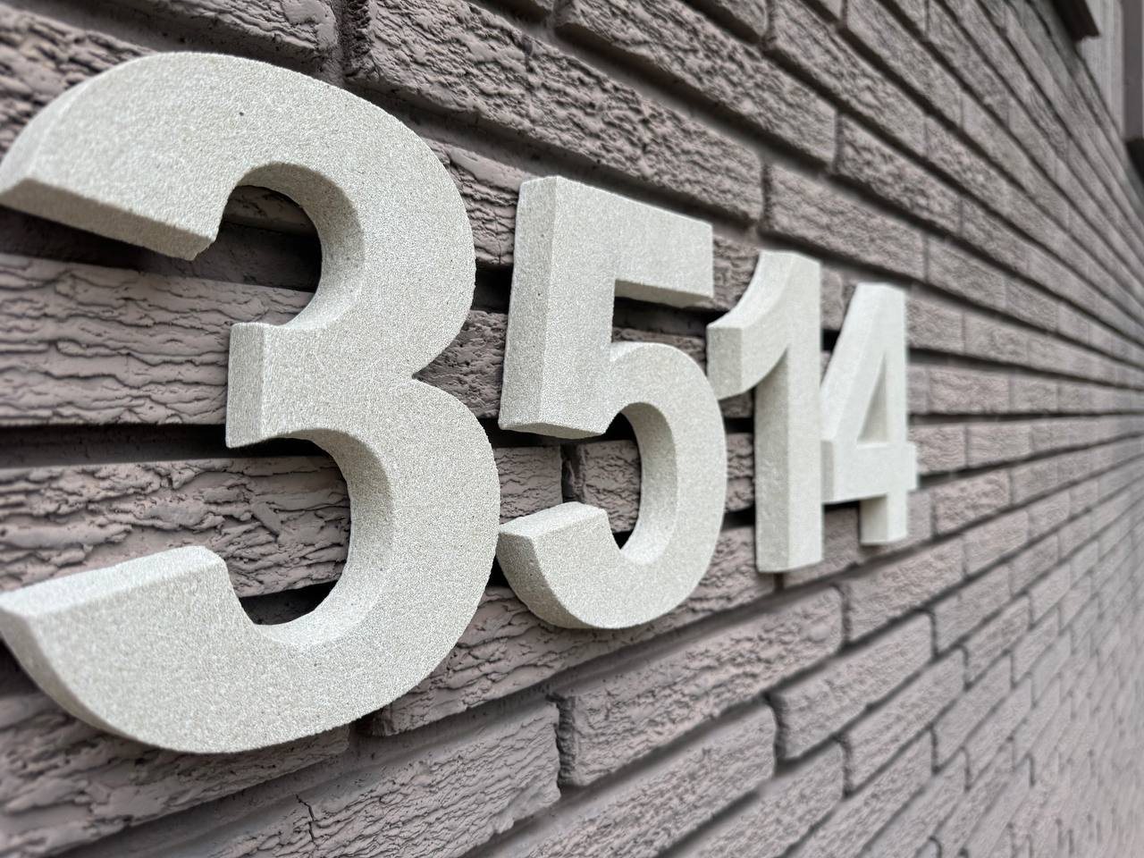 Side angle close-up of thick raised 3514 stone numbers