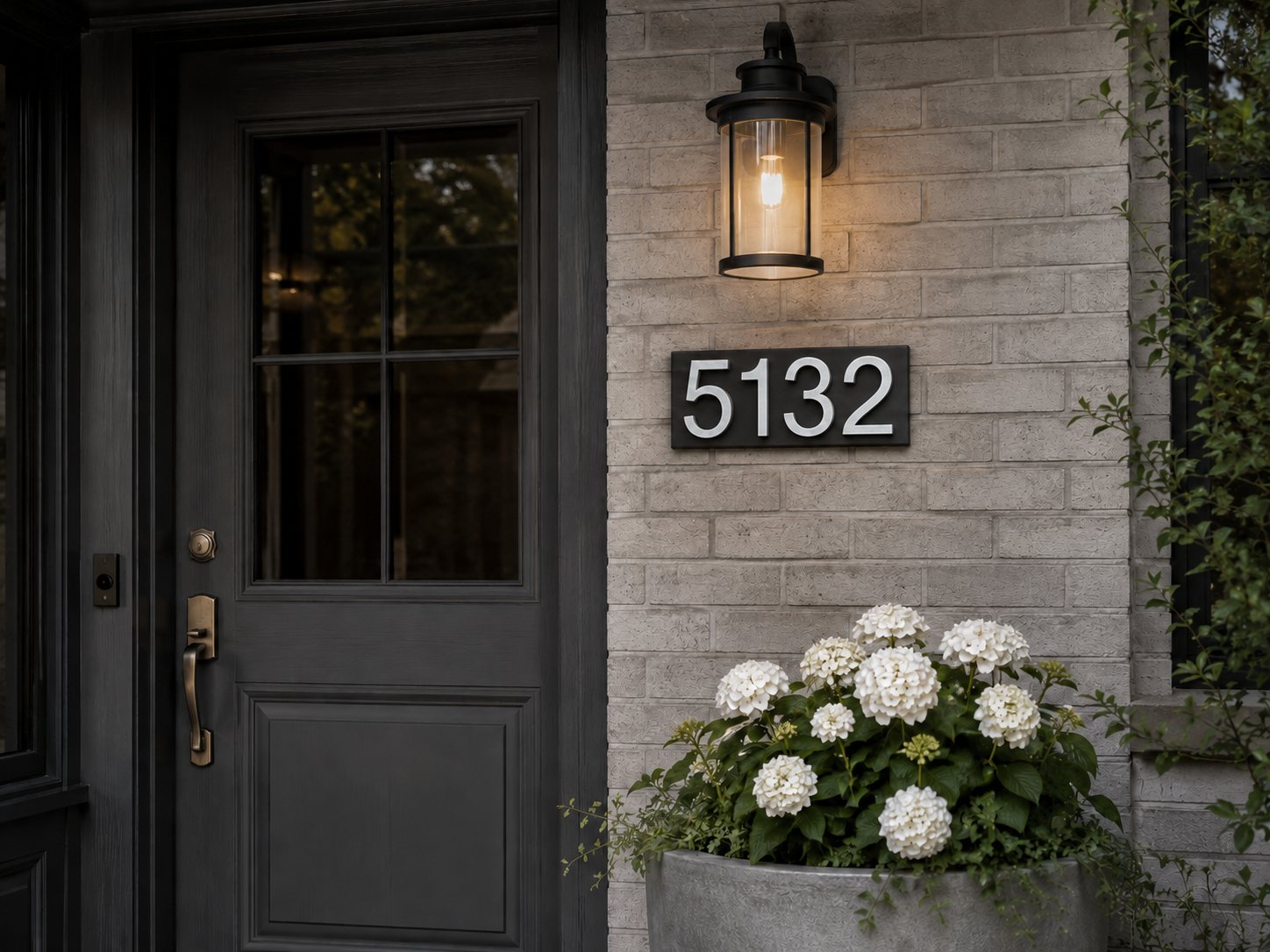 Front door with a 5132 custom stone address plaque on light brick
