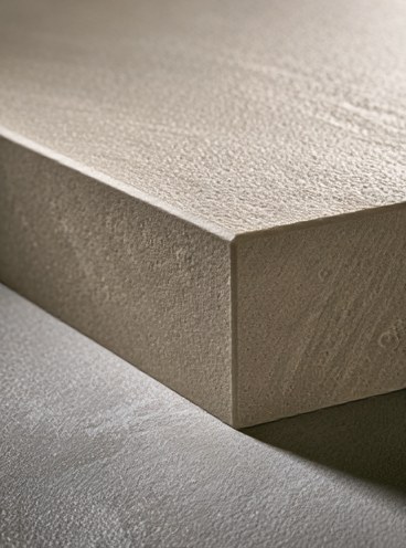 Close-up of matte sandstone-style texture on a sharp exterior stone block